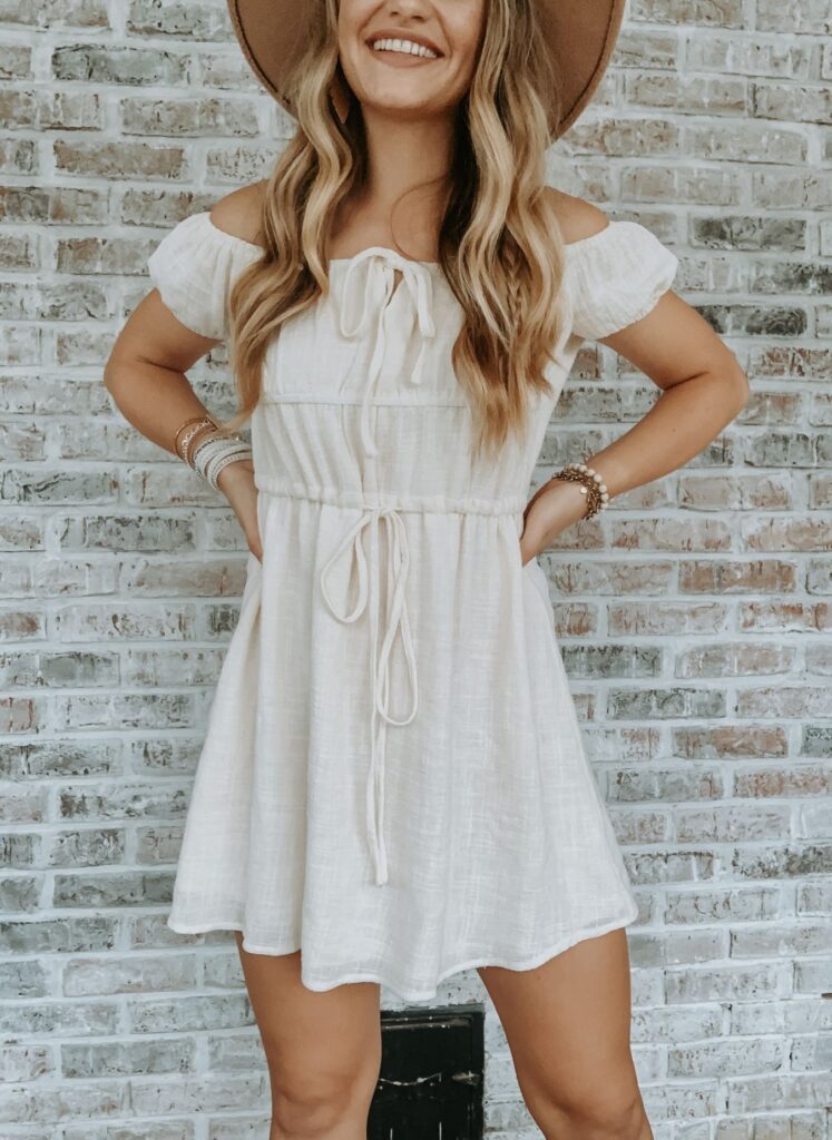 Model wearing cream country girl style dress